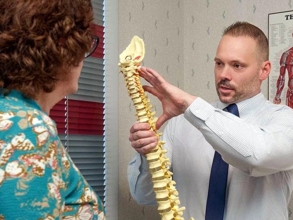 Dr. Allan Petrilak explaining the spine to a patient at Cedar Crest Chiropractic in Allentown