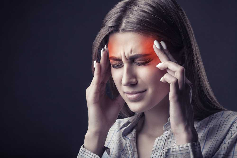 Tension headache vs migraine pain shown as woman holds head with eyes closed in distress.